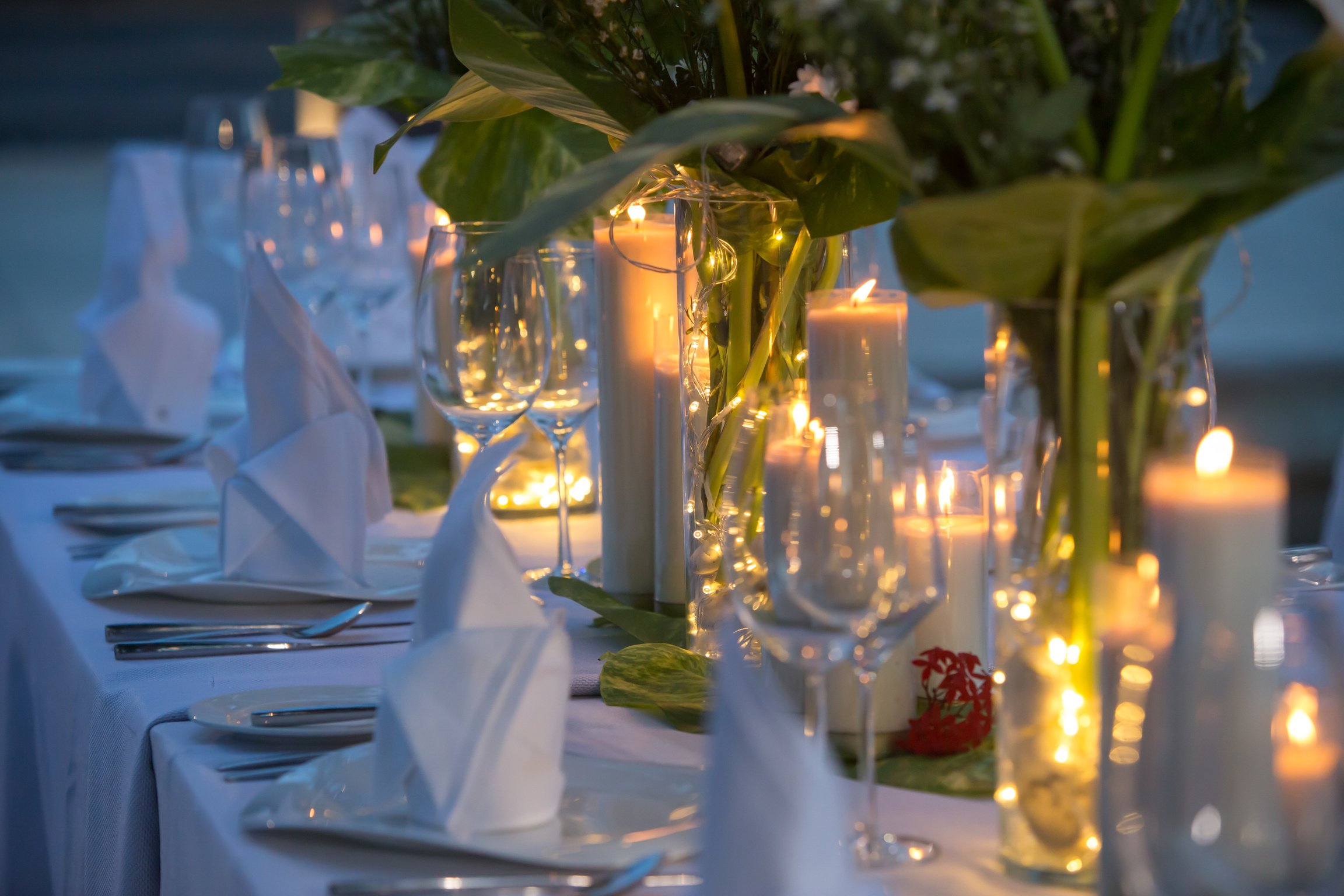 Wedding Banquet or gala dinner decorated with garlands. Festive table set up decor for wedding, party or event